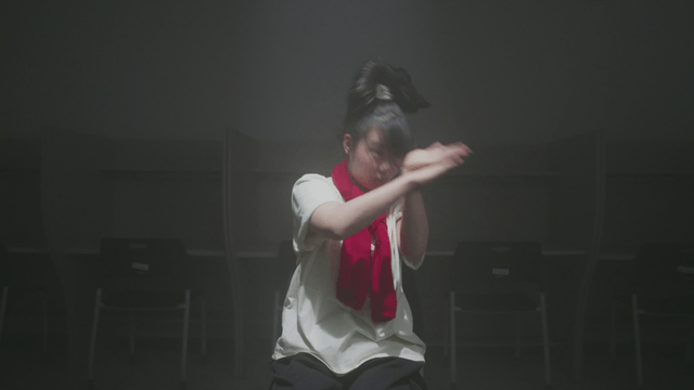 Girl dancing energetically in the reading room