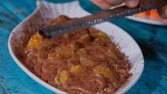 Grating chocolate over a dessert dish