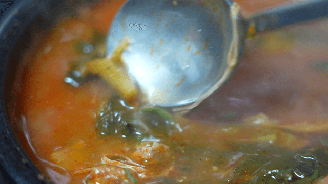 Simmering beef hangover soup in pot