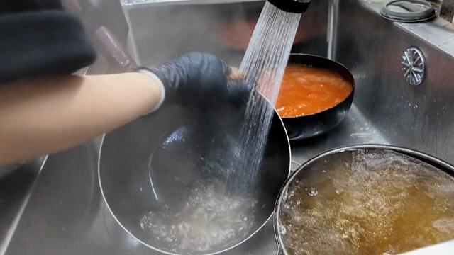 Washing dishes in a busy kitchen