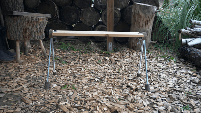 Handcrafted wooden bench placed in outdoor woodworking area