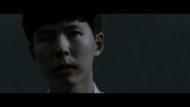 Man speaking with bruised lips in dark room