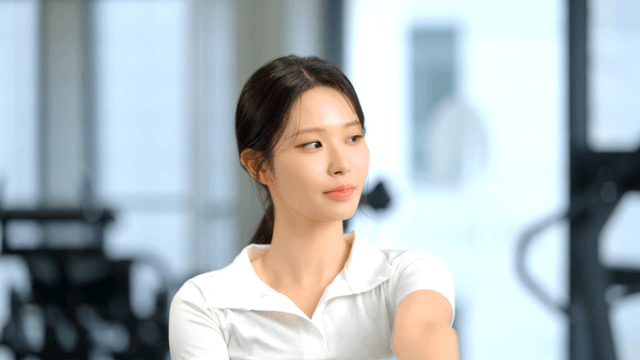Woman stretching arms at gym