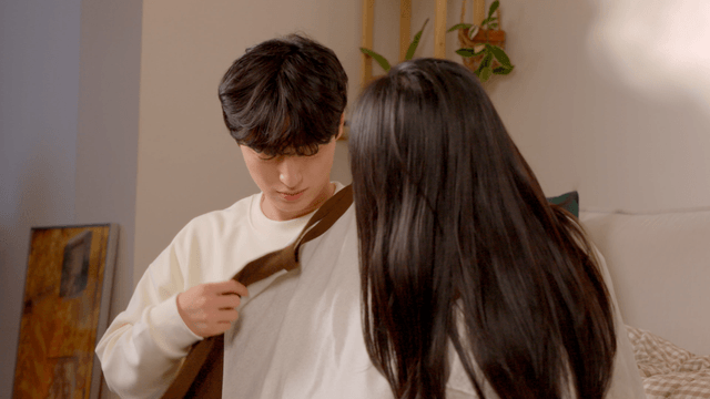 Couple folding clothes together with smiles