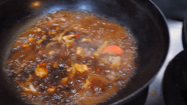 Braised chicken boiling in a pot