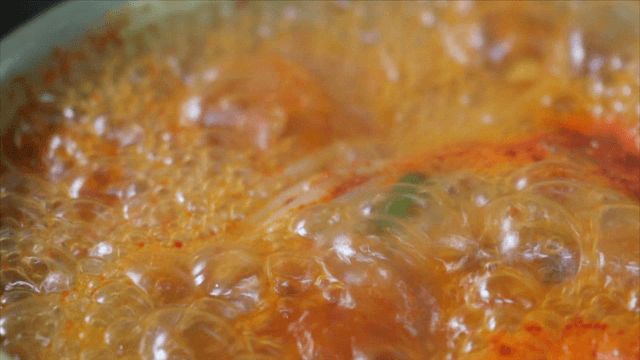 Spicy cod soup boiling in pot