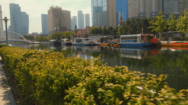Modern cityscape with canal and boats