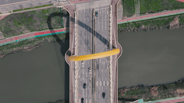Multilane bridge over river with moving vehicles