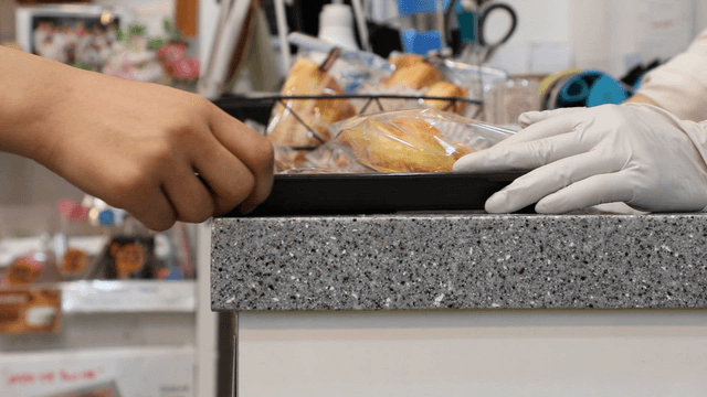 Bakery items being handled on a counter