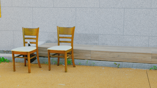 Wooden chairs and long bench by the wall