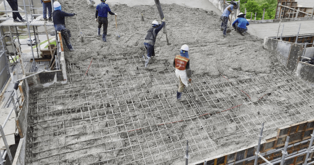 Workers pouring concrete on a building site
