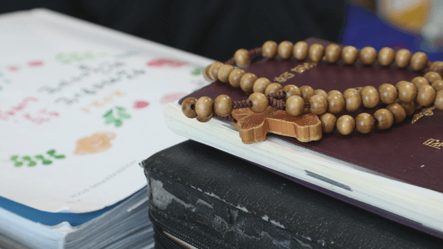 Wooden rosary beads on a notebook