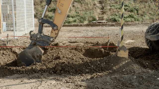 Excavator digging the marked area
