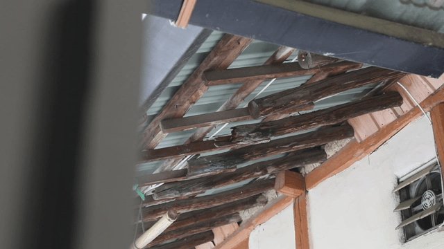 Old rural wooden beams and metal roof structure