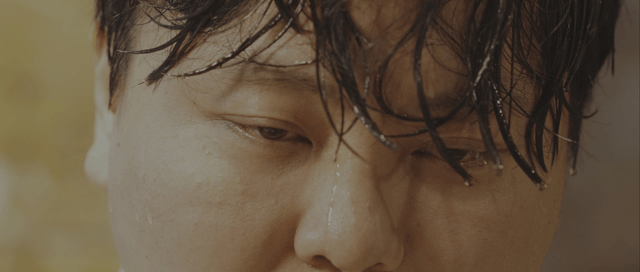 Person with wet hair and water droplets