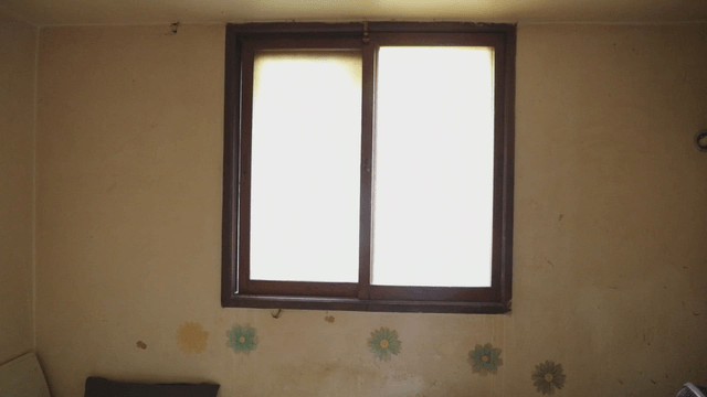 Simple room with a window and wall decor