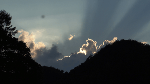 Sunlight shining through clouds over the mountains