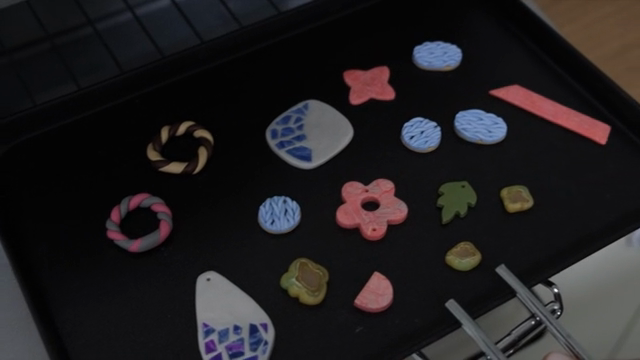 Colorful clay crafts on a baking tray