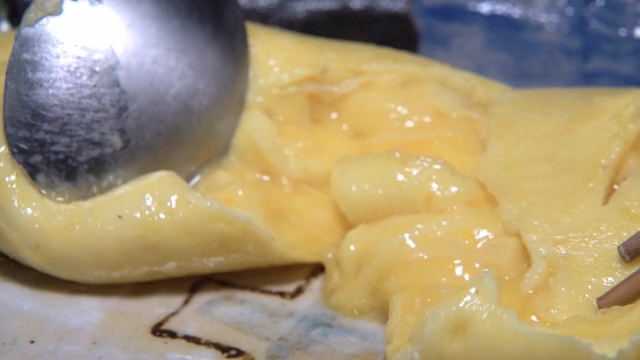 A fluffy omelette being sliced open