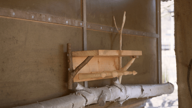 Wooden wall shelf on a simple wall