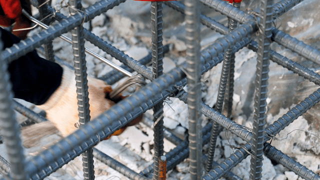Worker tying rebar at a construction site