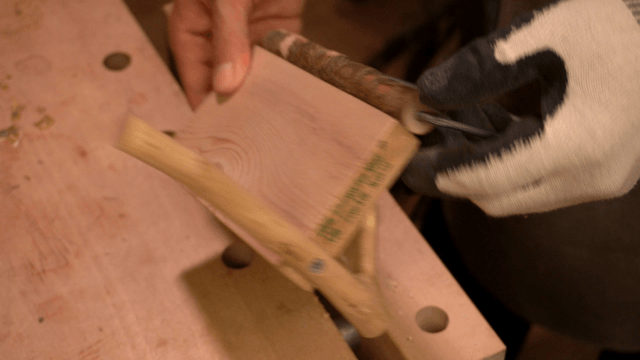 Woodcraft artisan connecting wooden pieces with nails and drill
