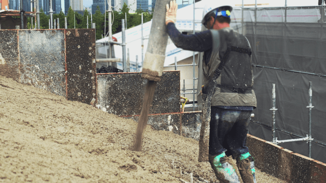Worker pouring concrete at a construction site