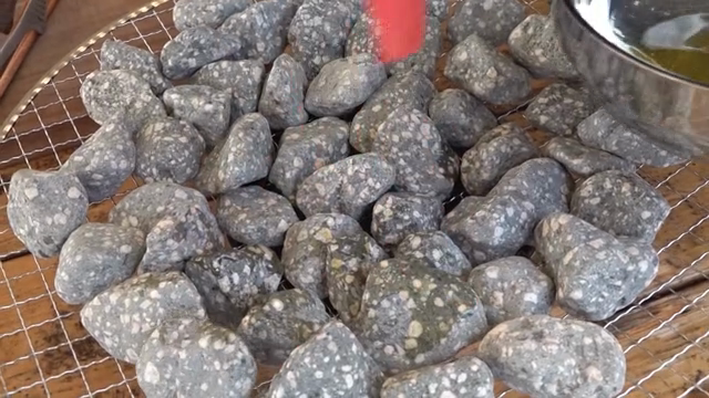 Brushing oil on stones for cooking