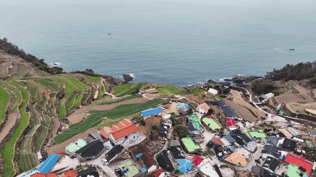 Colorful village by the sea with terraced fields