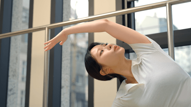 Woman stretching indoors