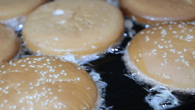 Burger buns frying in a pan