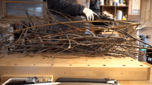 Craftsman arranging branches in a workshop