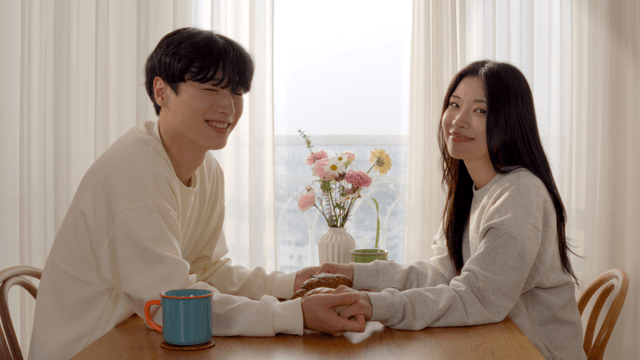 Couple holding hands at breakfast table