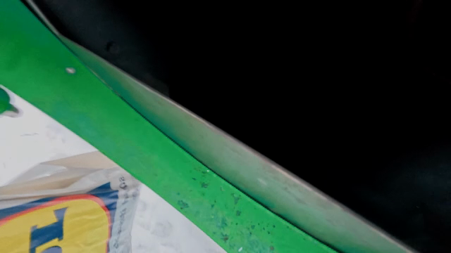 Recycling newspapers in a green bin