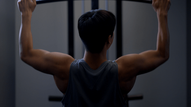 Man doing lat pulldown workout in gym