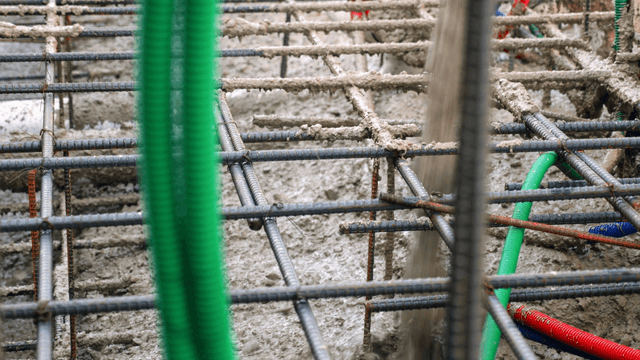Concrete pouring over rebar at a construction site