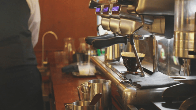 A barista preparing coffee at a cafe