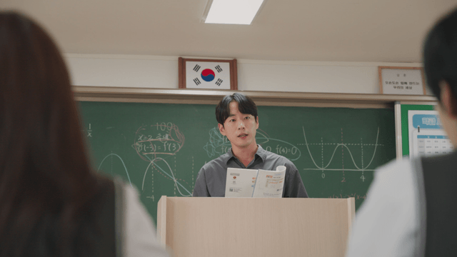Teacher explaining math in a classroom