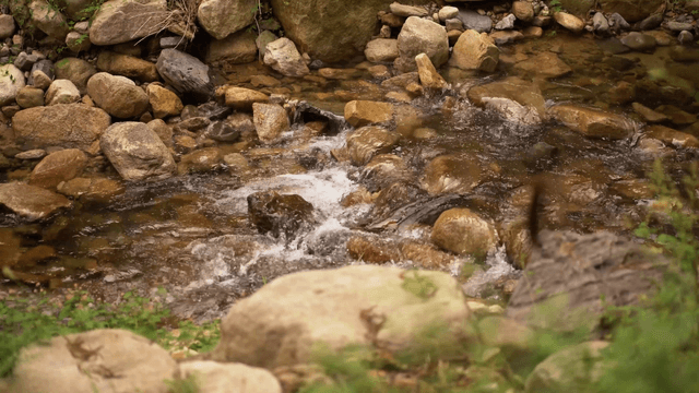 Small clear stream flowing over rock