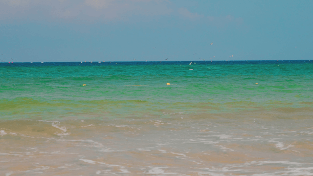 Waves gently crashing on a sandy beach