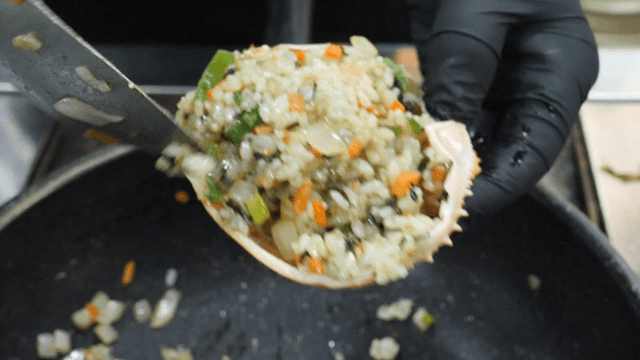 Stuffing rice into a crab shell
