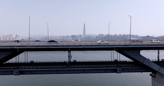 A bridge over a river with city skyline