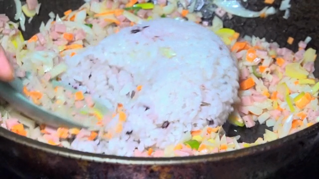 Rice and vegetables being stir-fried