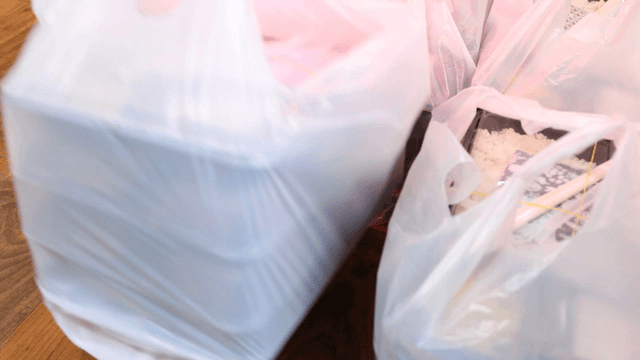 Plastic bags with packed meals on a table