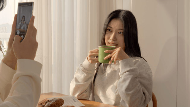 Couple taking photo with smartphone at breakfast table