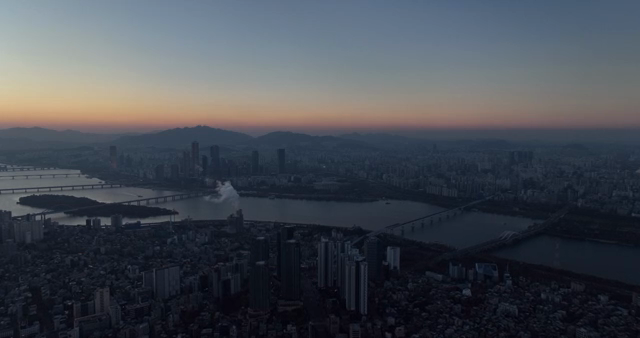 City skyline with river at sunset