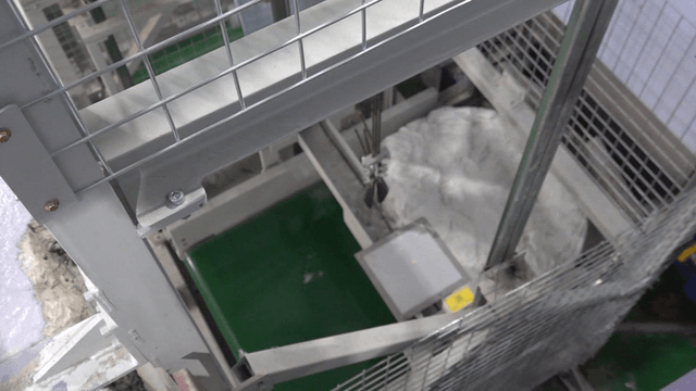 Large white disc moving on factory conveyor belt