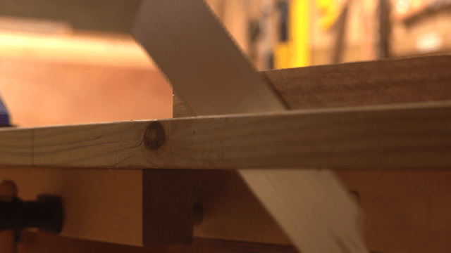 Wood being cut with a hand saw