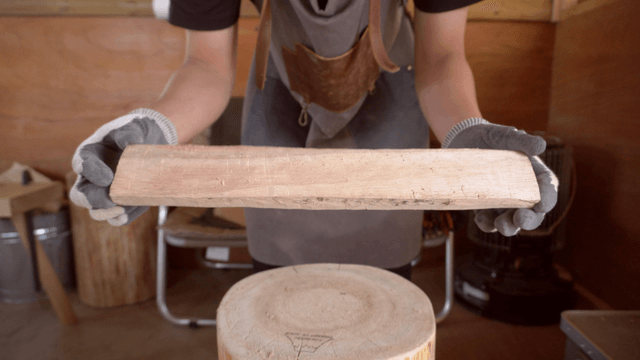 Woodcraft artisan inspecting wooden boards