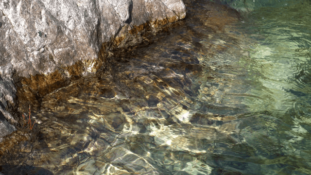 Clear stream flowing beside rocks